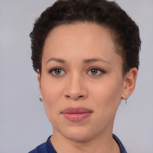 Joyful black young-adult female with short  brown hair and brown eyes
