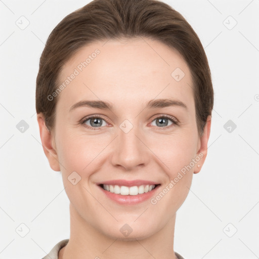 Joyful white young-adult female with short  brown hair and grey eyes