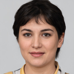 Joyful white young-adult female with medium  brown hair and brown eyes