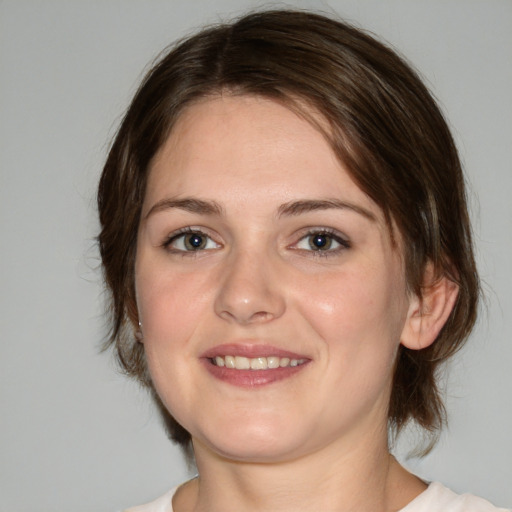 Joyful white young-adult female with medium  brown hair and green eyes