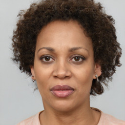 Joyful black adult female with short  brown hair and brown eyes