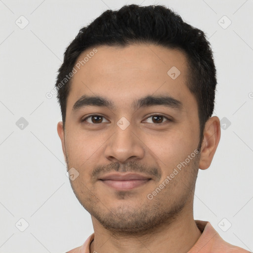 Joyful latino young-adult male with short  black hair and brown eyes