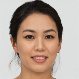 Joyful asian young-adult female with medium  brown hair and brown eyes