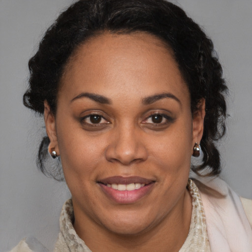 Joyful latino adult female with medium  brown hair and brown eyes