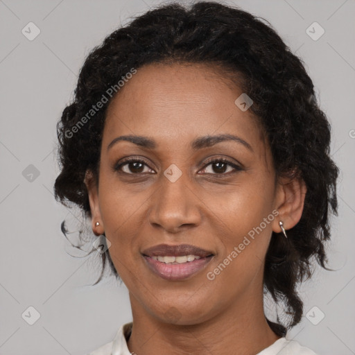 Joyful black adult female with medium  brown hair and brown eyes