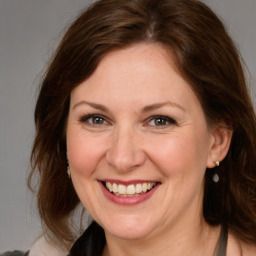 Joyful white adult female with medium  brown hair and brown eyes