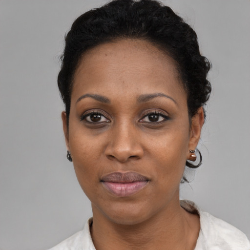 Joyful black adult female with short  black hair and brown eyes