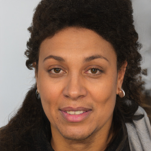 Joyful white adult female with long  brown hair and brown eyes