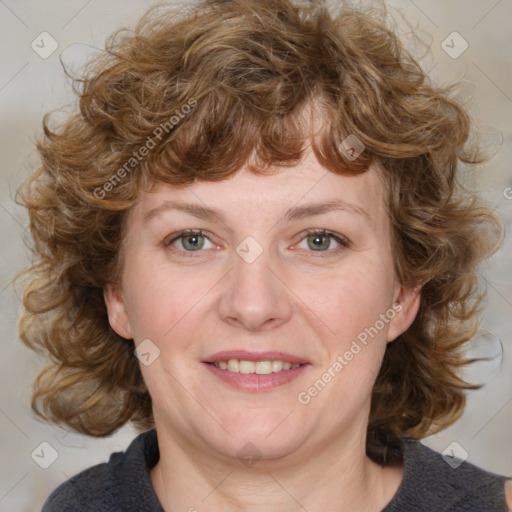 Joyful white adult female with medium  brown hair and blue eyes