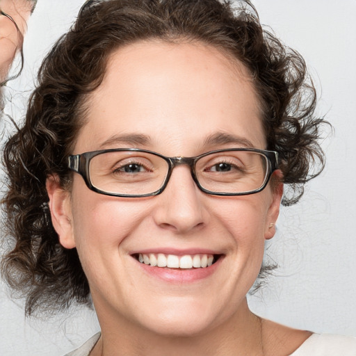 Joyful white adult female with medium  brown hair and blue eyes