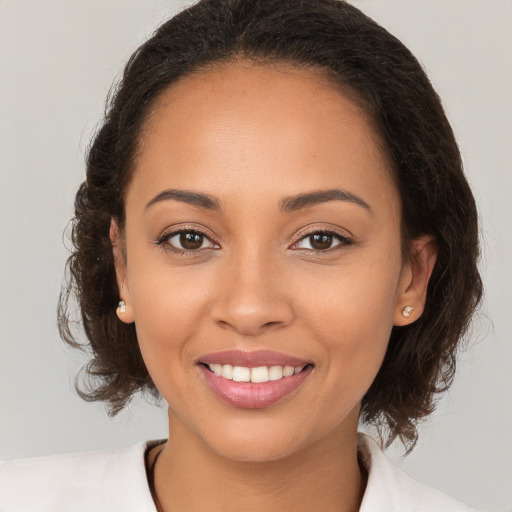 Joyful white young-adult female with medium  brown hair and brown eyes