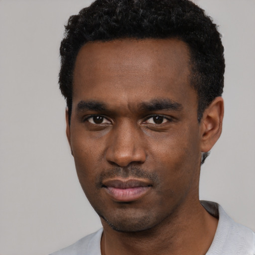 Neutral black young-adult male with short  black hair and brown eyes