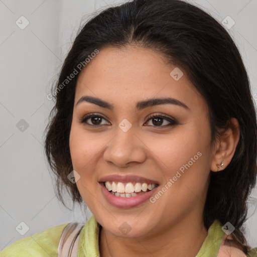 Joyful latino young-adult female with long  brown hair and brown eyes