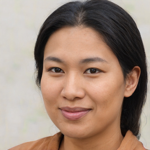 Joyful asian young-adult female with medium  brown hair and brown eyes