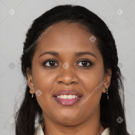 Joyful black young-adult female with long  brown hair and brown eyes