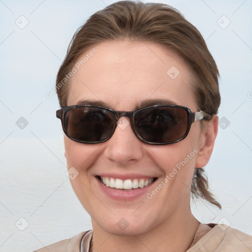 Joyful white young-adult female with medium  brown hair and blue eyes