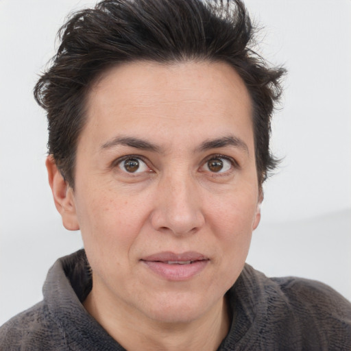 Joyful white adult female with short  brown hair and brown eyes