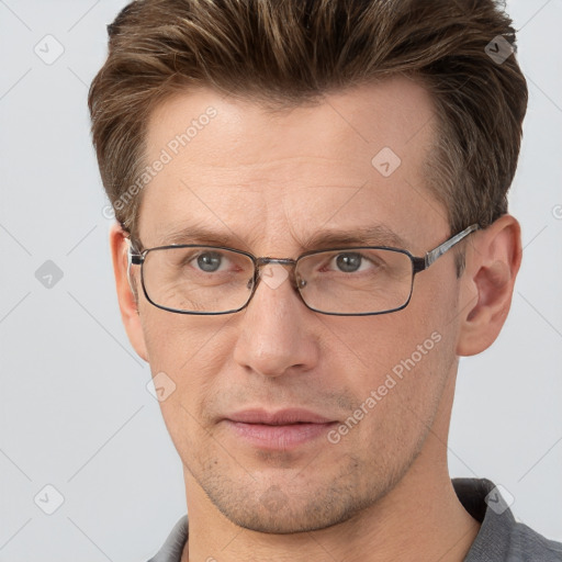 Joyful white adult male with short  brown hair and grey eyes