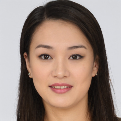 Joyful asian young-adult female with long  brown hair and brown eyes