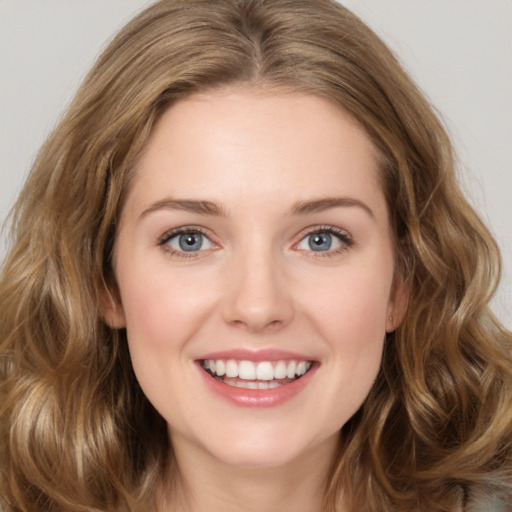 Joyful white young-adult female with long  brown hair and green eyes