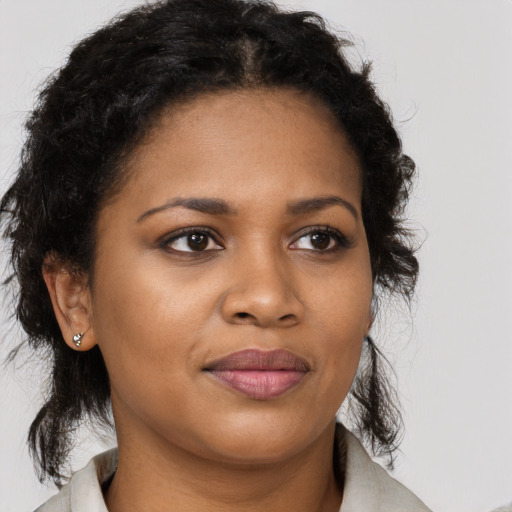 Joyful black young-adult female with medium  brown hair and brown eyes