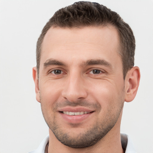 Joyful white young-adult male with short  brown hair and brown eyes