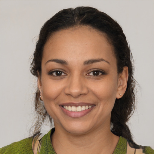 Joyful latino young-adult female with medium  brown hair and brown eyes