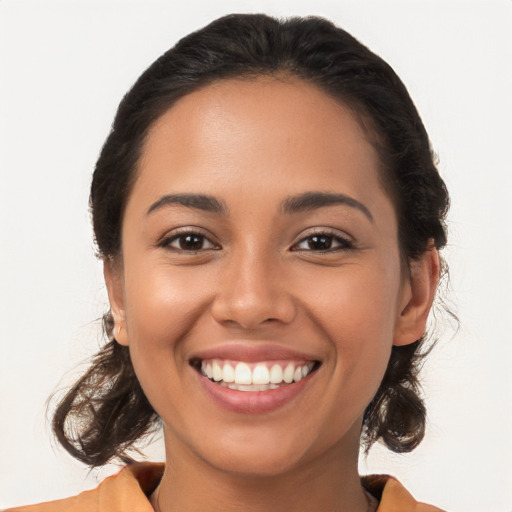 Joyful latino young-adult female with long  brown hair and brown eyes