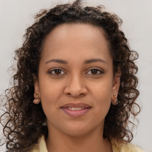 Joyful black young-adult female with long  brown hair and brown eyes