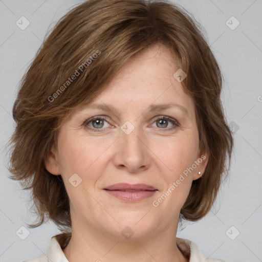 Joyful white adult female with medium  brown hair and grey eyes