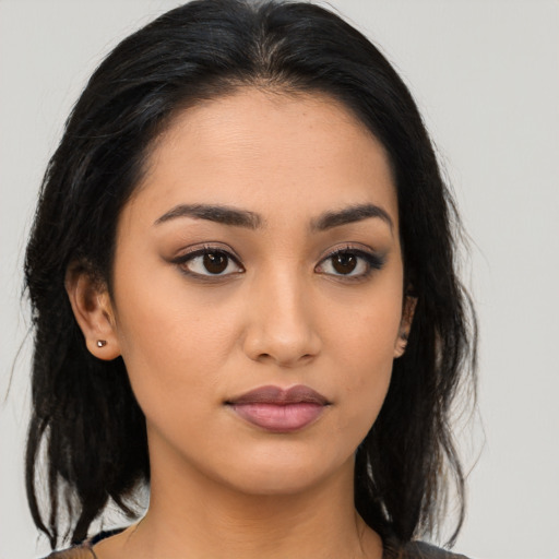 Neutral latino young-adult female with medium  brown hair and brown eyes