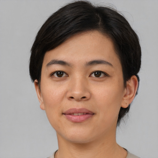 Joyful asian young-adult female with short  brown hair and brown eyes