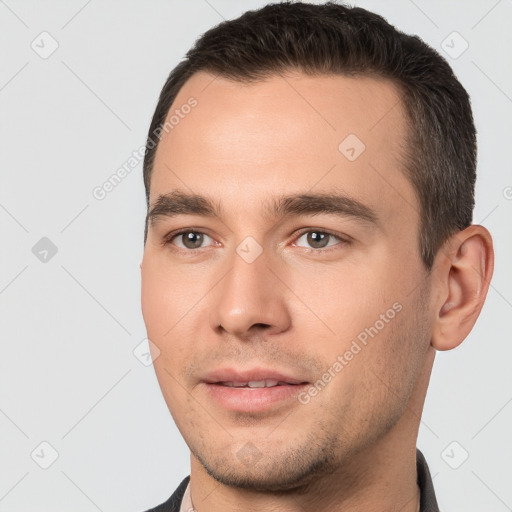 Joyful white young-adult male with short  black hair and brown eyes