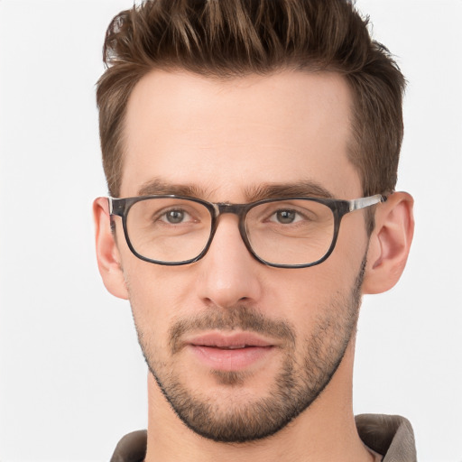 Joyful white young-adult male with short  brown hair and grey eyes