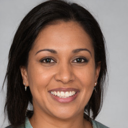 Joyful white adult female with medium  brown hair and brown eyes