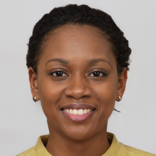 Joyful black young-adult female with short  brown hair and brown eyes