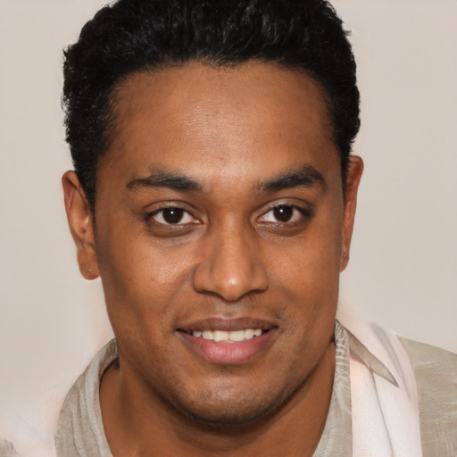 Joyful black young-adult male with short  black hair and brown eyes