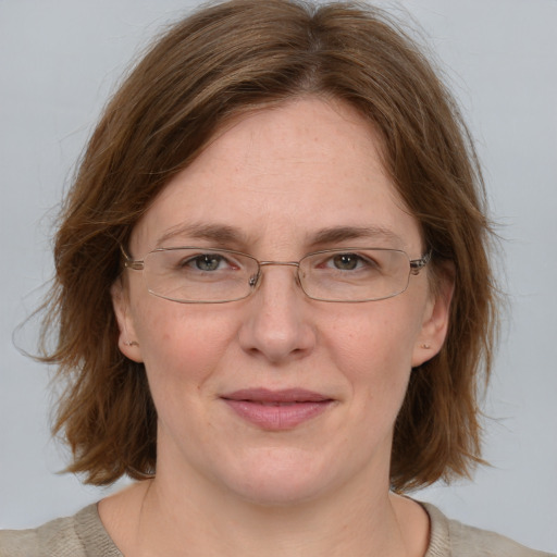 Joyful white adult female with medium  brown hair and blue eyes