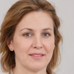 Joyful white adult female with medium  brown hair and grey eyes