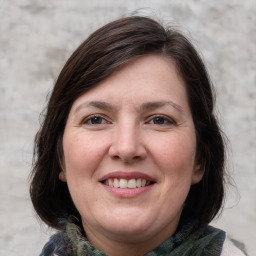 Joyful white adult female with medium  brown hair and grey eyes