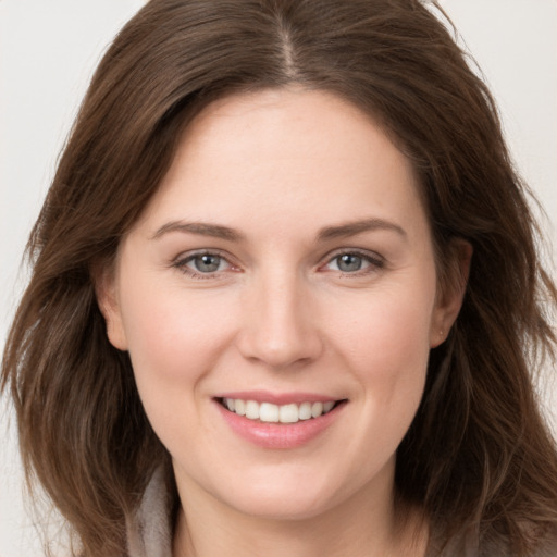 Joyful white young-adult female with long  brown hair and grey eyes