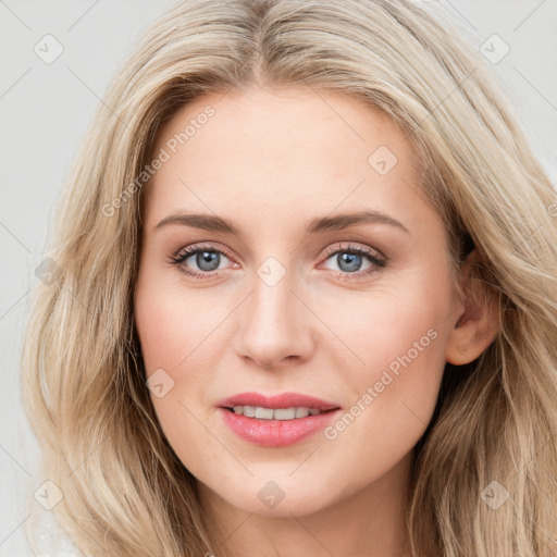 Joyful white young-adult female with long  brown hair and blue eyes