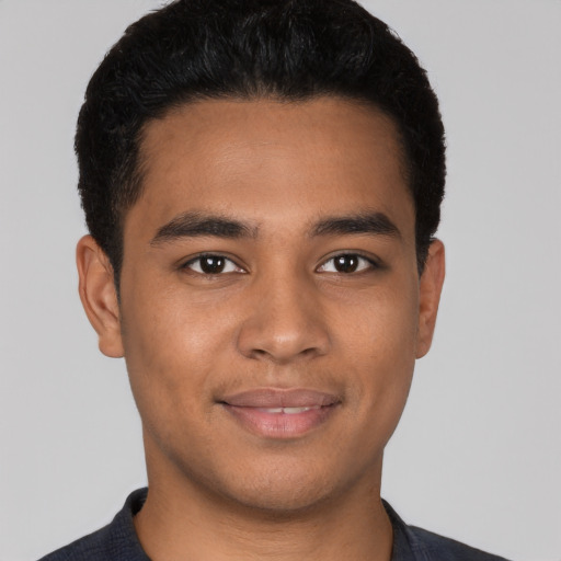 Joyful latino young-adult male with short  black hair and brown eyes