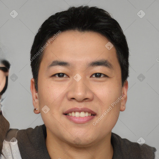 Joyful asian young-adult male with short  black hair and brown eyes