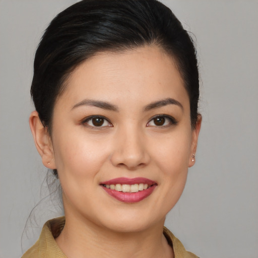 Joyful asian young-adult female with medium  brown hair and brown eyes