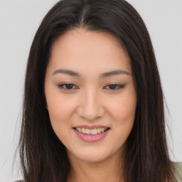 Joyful asian young-adult female with long  brown hair and brown eyes