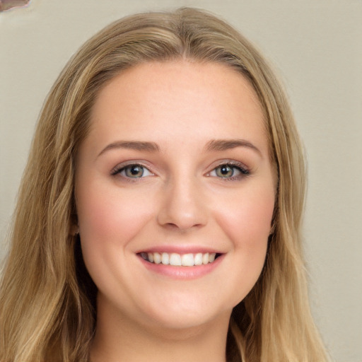 Joyful white young-adult female with long  brown hair and blue eyes