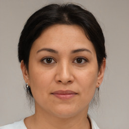 Joyful white adult female with medium  brown hair and brown eyes