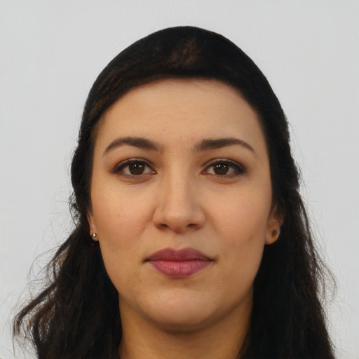 Joyful latino young-adult female with long  black hair and brown eyes