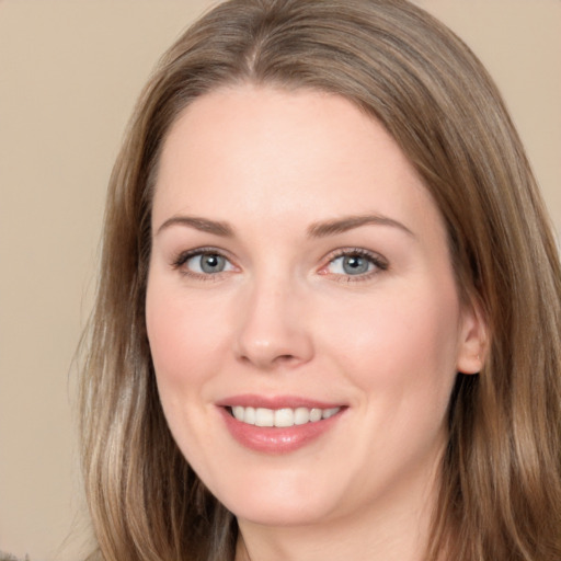 Joyful white young-adult female with long  brown hair and brown eyes